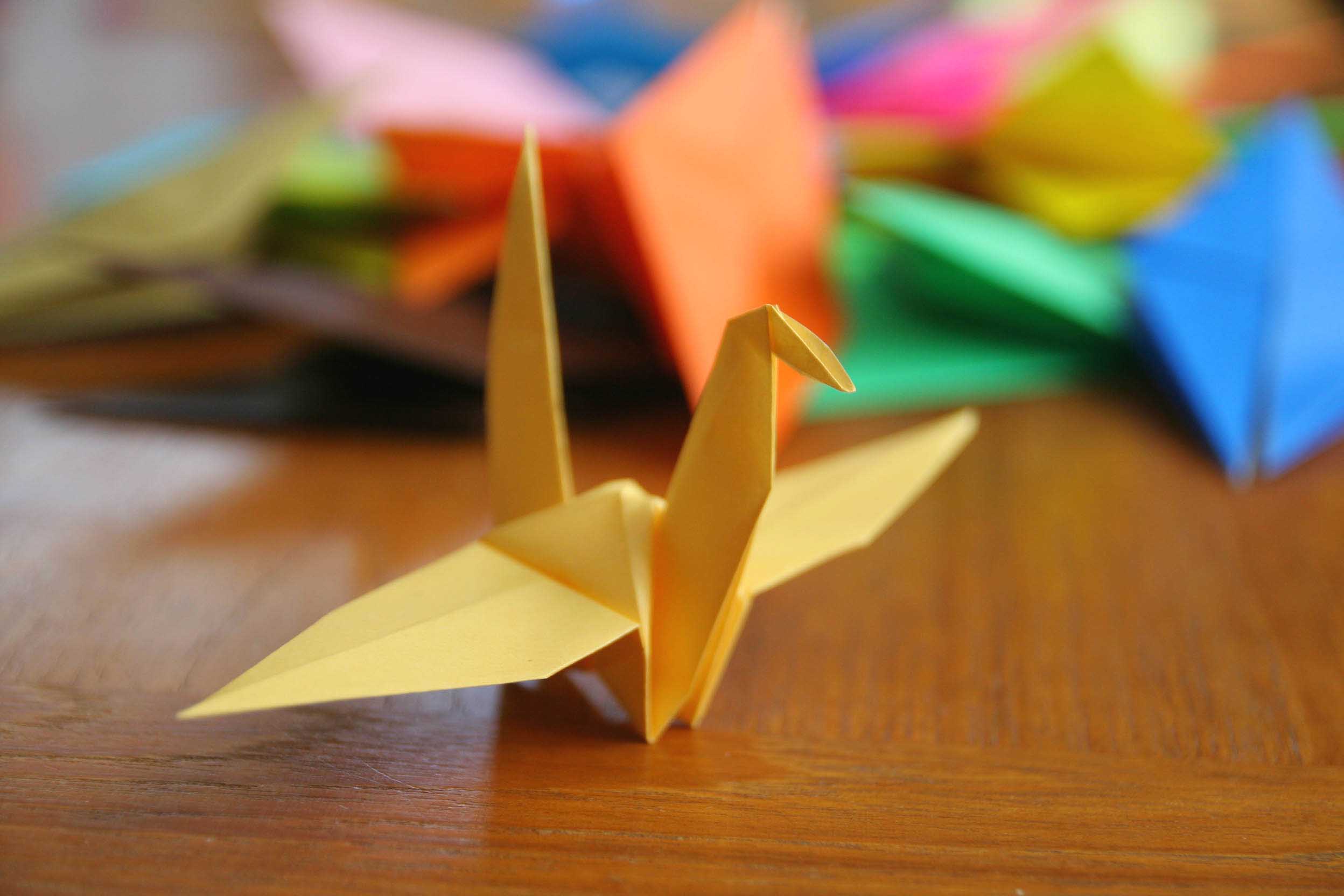 Red Origami Paper Cranes Flying Away From Hands Photo Photograph