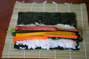 Hot dogs and vegetables on sushi rice
