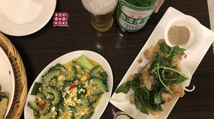 Plates of stir-fried Chinese okra and salt and pepper chicken